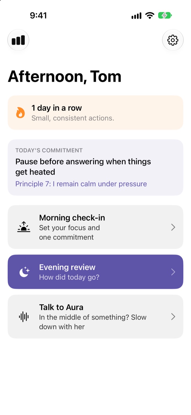 Aura's home screen showing a one-day streak, today's commitment to pause before answering when things get heated, and buttons for the morning check-in, evening review and talking to Aura.